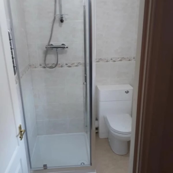 Small en suite with a new shower enclosure and toilet